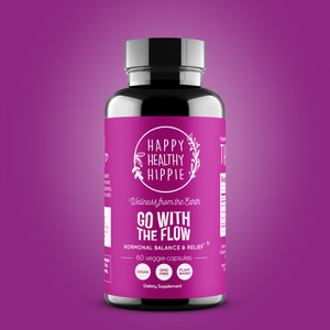 A bottle of 'Go With The Flow' supplement by Happy Healthy Hippie with a pink label, 60 veggie caps, and a focus on hormone balance and relief.