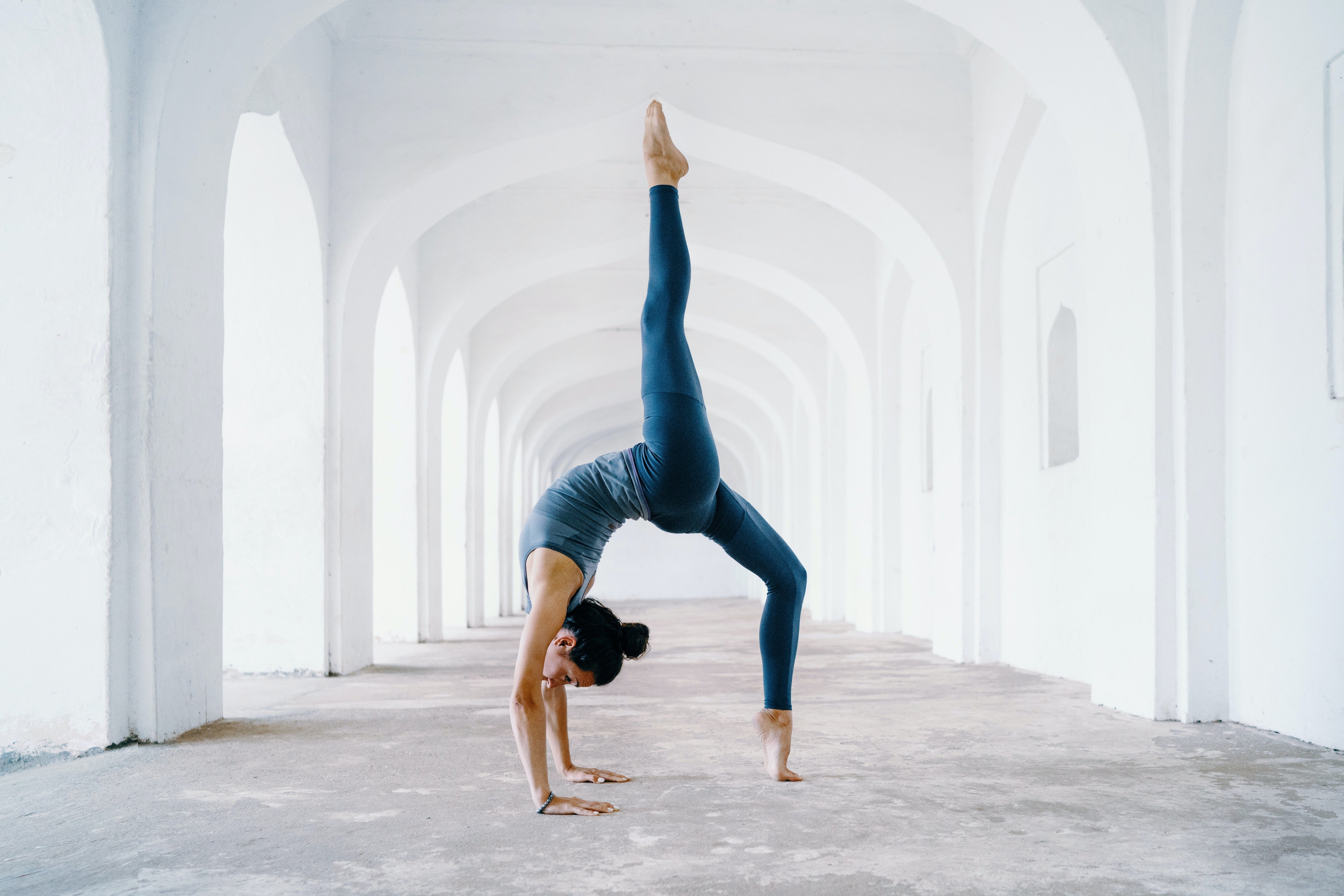 A woman doing a yoga pose on a blue surface photo – Yoga pose Image on  Unsplash