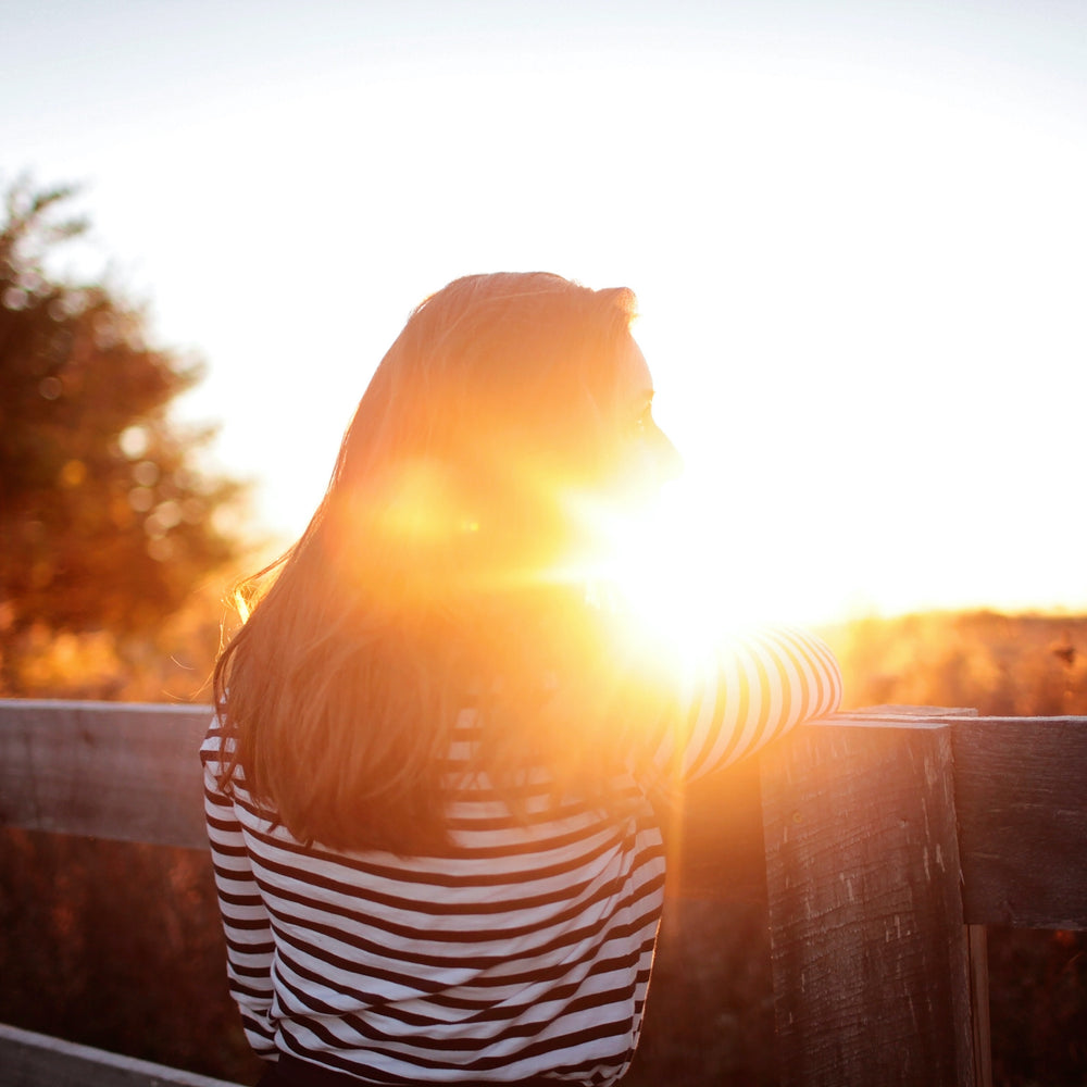 
                    Woman in front of a sunset - High Estrogen in Women [What Causes It & How to Fix It]