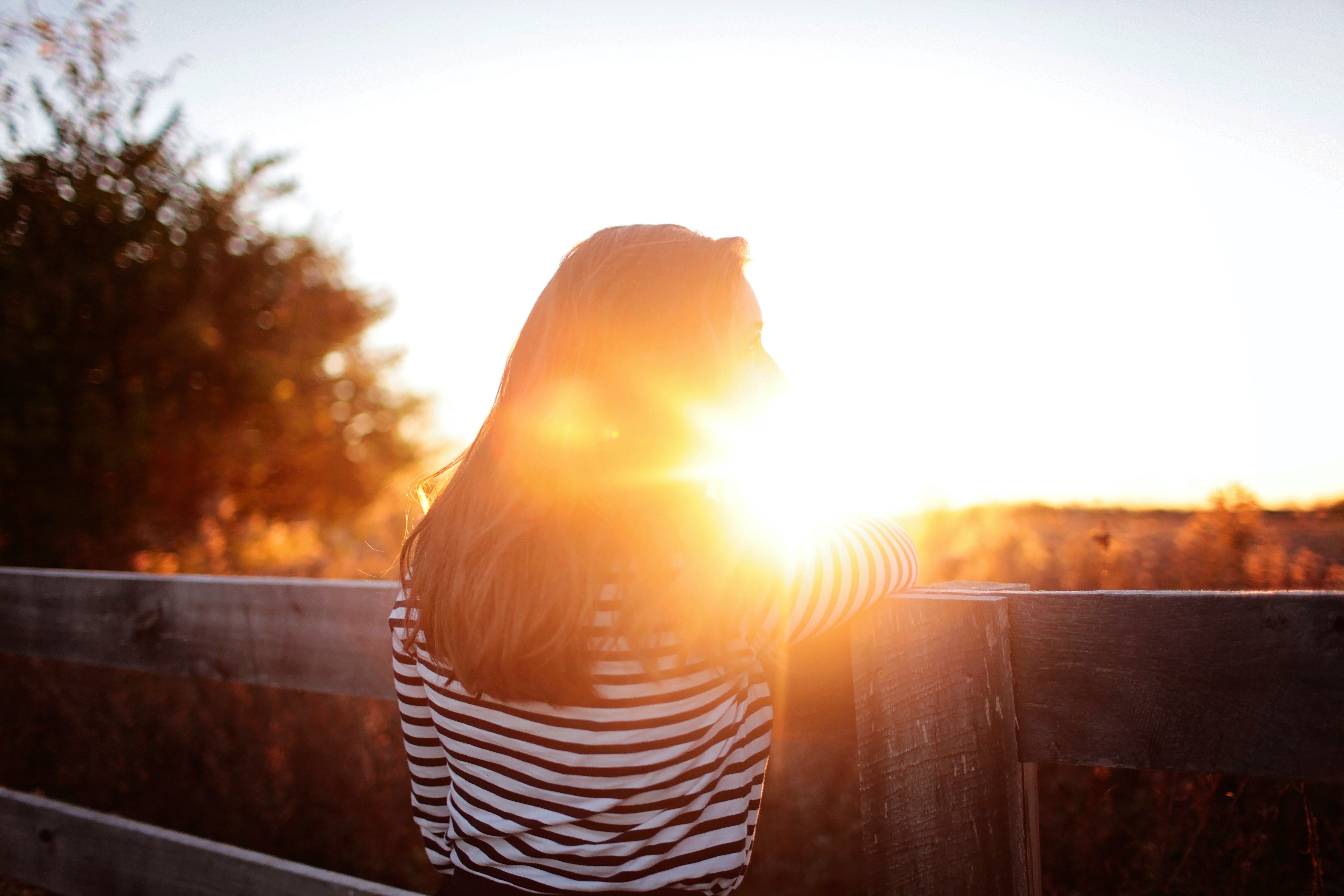 Woman in front of a sunset - High Estrogen in Women [What Causes It & How to Fix It]